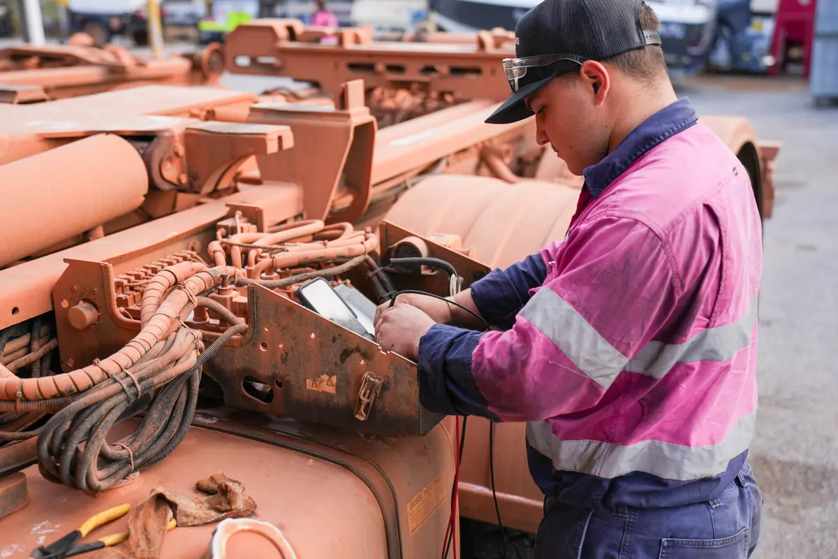 ACES technician testing equipment on a mine-spec truck